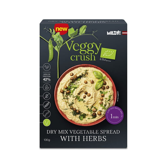 Bio-Gemüsepaste mit Kräutern von Veggy Crush, 130 g, in einem Glas mit grünen Kräutern und frischer Gemüsescheibe sichtbar