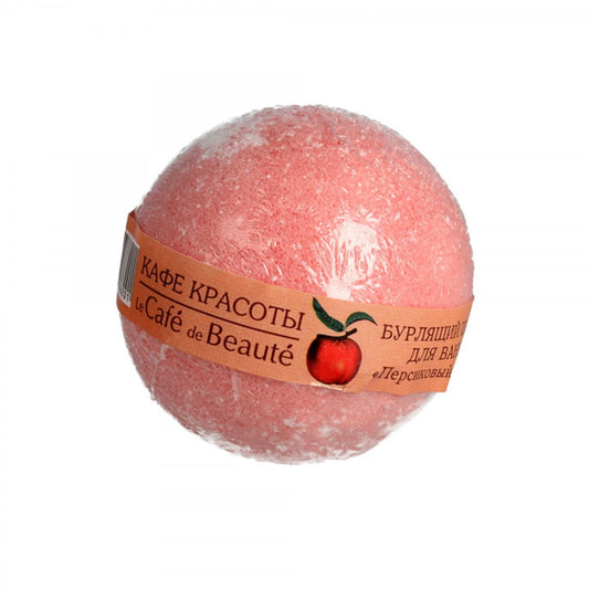Badebombe Pfirsich von DesignSoap, 120 g, mit rosa und orangefarbenen Mustern, liegt auf einer weißen Oberfläche.